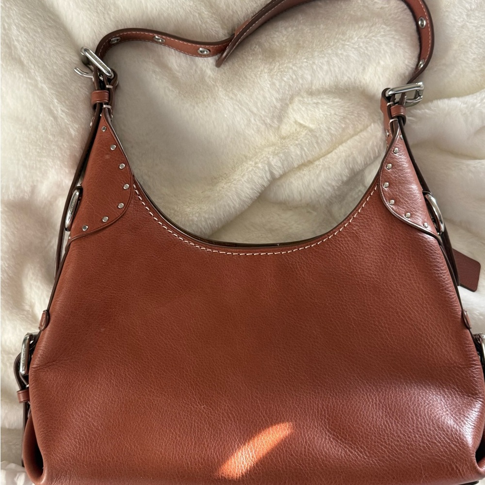 Coach western shoulder bag.  burnished amber  with silver hardware.
